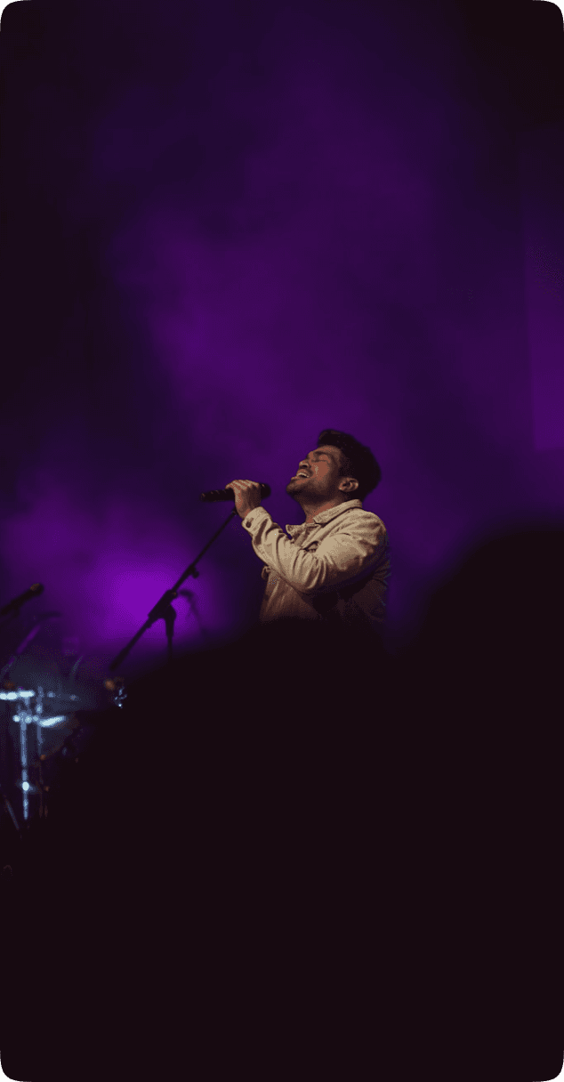 Singer performing with purple lighting
